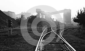 Black and white industrial landscape with railway rails