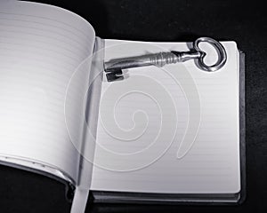 Black and white key on writing journal