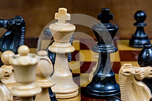 Black and white kings and other chess figures on a chess board