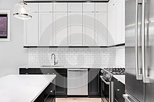 A black and white kitchen detail with a subway tile backsplash.