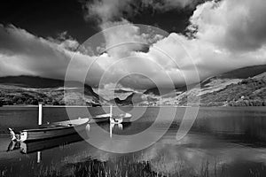 Black and white Landscape image of rowing boats on Llyn Nantlle