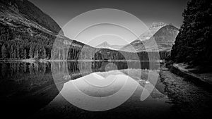 Black and White landscape photo of Mt. Wilbur reflection in Fishercap Lake at sunrise in Glacier National Park photo