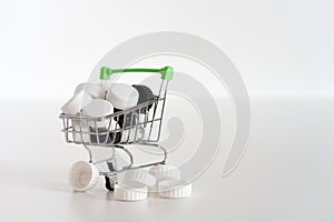 Black and white lids in a small shopping cart