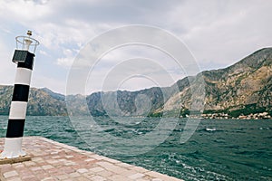 Black and white lighthouse in the sea. Prcanj, Kotor Bay, Monten