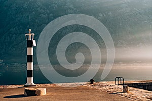 Black and white lighthouse in the sea. Prcanj, Kotor Bay, Monten