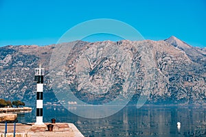 Black and white lighthouse in the sea. Prcanj, Kotor Bay, Monten