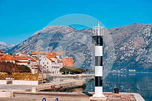 Black and white lighthouse in the sea. Prcanj, Kotor Bay, Monten