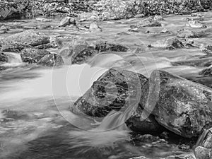 Black and white long exposure of a stream cascading over rocks in Montana