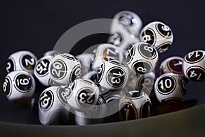 Black and white lottery balls in a machine 13