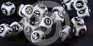 Black and white lottery balls in a machine