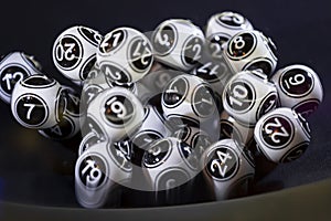 Black and white lottery balls in a machine