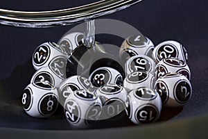 Black and white lottery balls in a machine