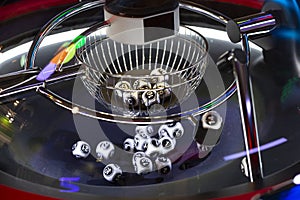 Black and white lottery balls in a rotating bingo machine. Number 14