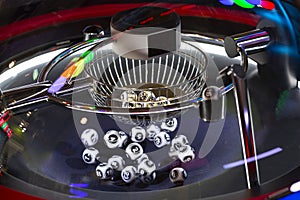 Black and white lottery balls in a rotating bingo machine. Number 16