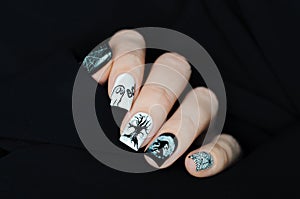 Black and white manicure on Halloween with tree, witch, moon, spider web and ghost BOO
