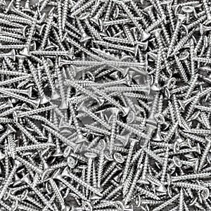 Black and white metal screws background and texture