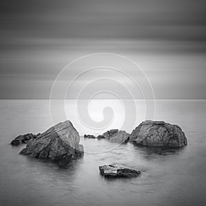 Black & White minimalist seascape with rocks.