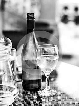 Black and White Monochrome Image of a Glass of White wine Next T