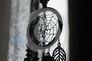 Black and White Monochrome Silhoutte of A Dreamcatcher Beside the Window
