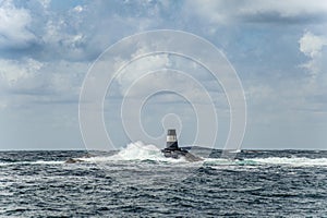 A black and white navigational mark on a small skerry