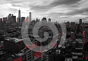 Black and white New York City skyline buildings at night with red lights of the downtown Manhattan skyscrapers