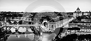 Black and white night view of St. Peter's Basilica and the Tiber river in Vatican City, Rome, Italy