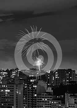 Black and white nighttime images with New Year`s, RÃÂ©veillon, fireworks exploding in the sky. Event held for the 2022 arrival photo