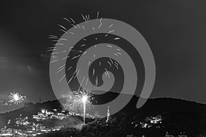 Black and white nighttime images with New Year`s, RÃ©veillon, fireworks exploding in the sky. Event held for the 2022 arrival