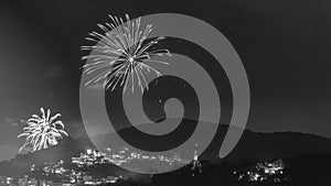 Black and white nighttime images with New Year`s, RÃ©veillon, fireworks exploding in the sky. Event held for the 2022 arrival