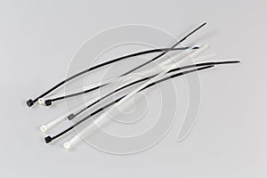 Black and white nylon unfastened cable ties on gray background