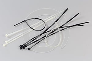 Black and white nylon unfastened cable ties on gray background