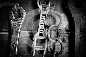 Black and white of old farm tools on wall