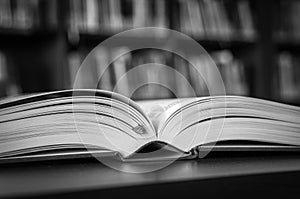 Black and white open book on the table in a library