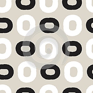 Black and white ovals on greige background seamless pattern.