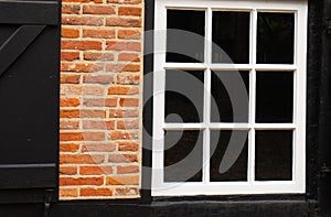 Black and white painted window and red bricks