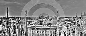 Black and white panorama photo of marble statues of Cathedral Duomo di Milano ,Milan cityscape and Galleria Vittorio Emanuele II