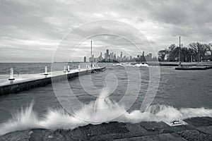 Black and white panoramic skyline view of Chicago from Fullerton Avenue during a windy day with water crashing up against concrete