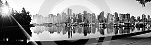 Black and white panoramic view of Vancouver skyline at sunrise as seen from Stanley Park, British Columbia, Canada