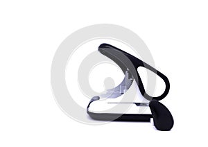 Black and white paper hole puncher, isolated on white background. Side view