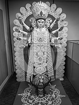 A black and white paper idol of Lord Durga during Durga Puja celebration at an office premises