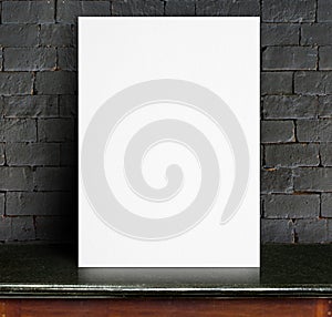 Black White paper poster lean at black brick wall and marble tab
