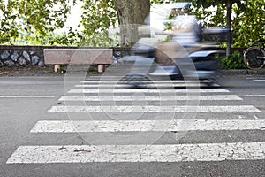 Black and white pedestrian crossing with a scooter on background