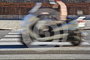 Black and white pedestrian crossing with a scooter on background