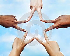 Black and white people forming five pointed star with their fingers.