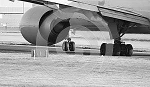 Black and white photo of 777-F port engine and undercarriage - stock photo