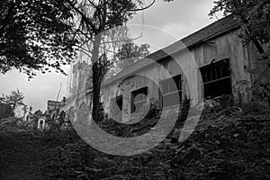 Black and white photo of an abandoned building