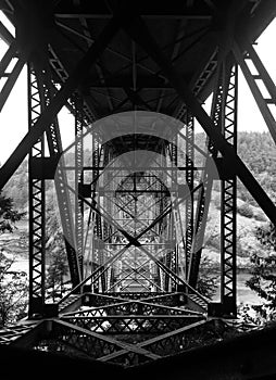 Black and white photo beneath the bridge at Deception Pass Washington