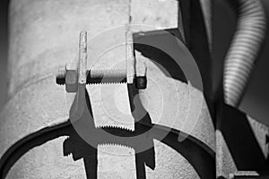 Black and white photo bolted metal pipe clamp