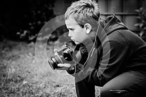 Black and white photo of a boy taking photo& x27;s