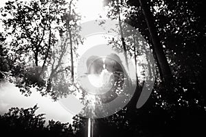 Black and white photo of cheerful emotional newlyweds